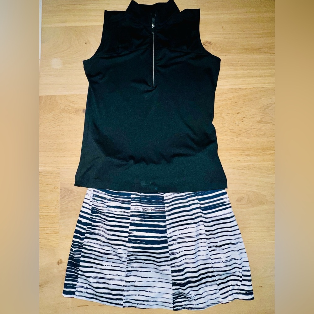Tail Golf skort in black/white and black sleeveless zip collar shirt